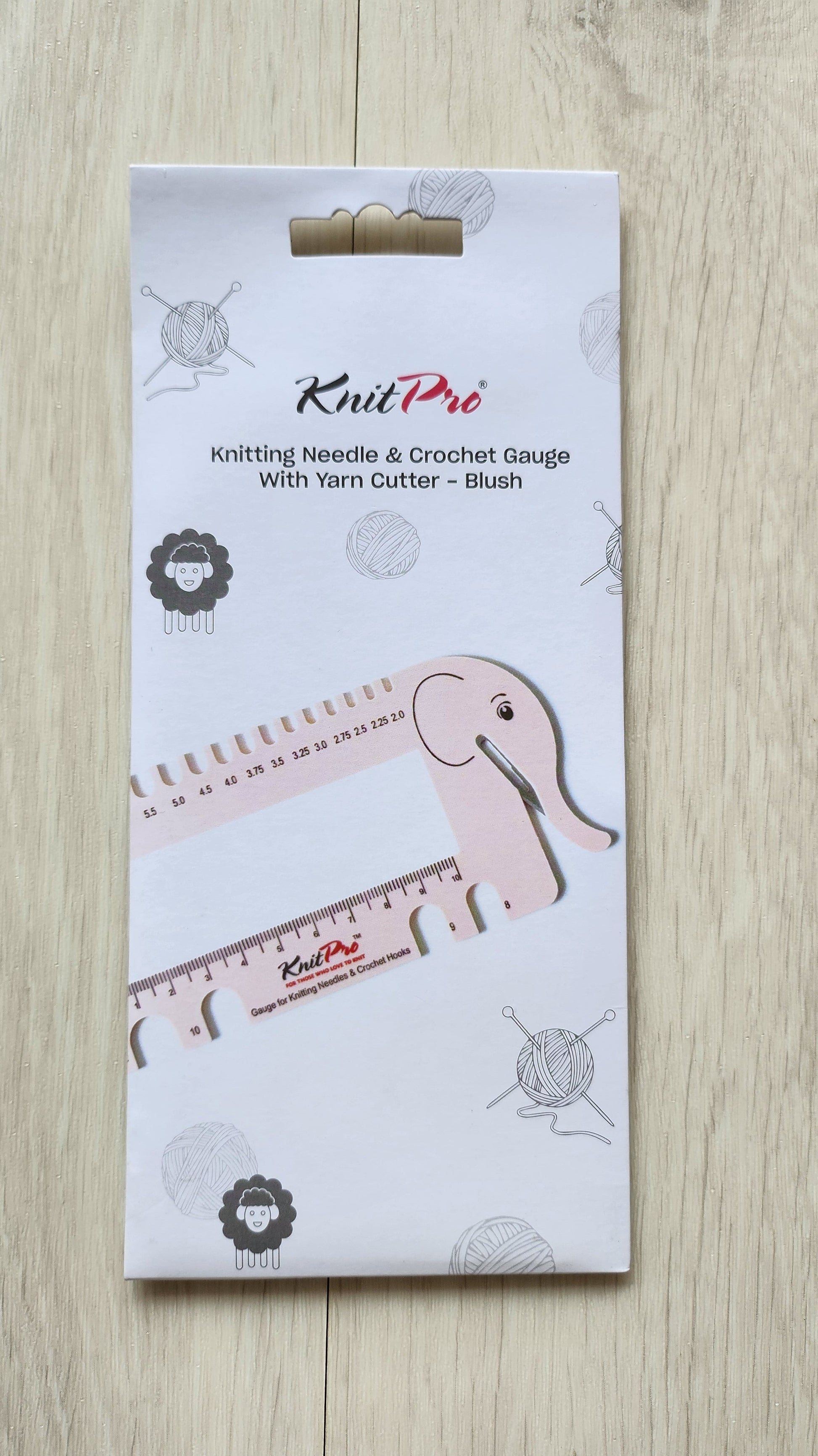 Knit Pro knitting needle and crochet gauge set packaging on a wooden surface