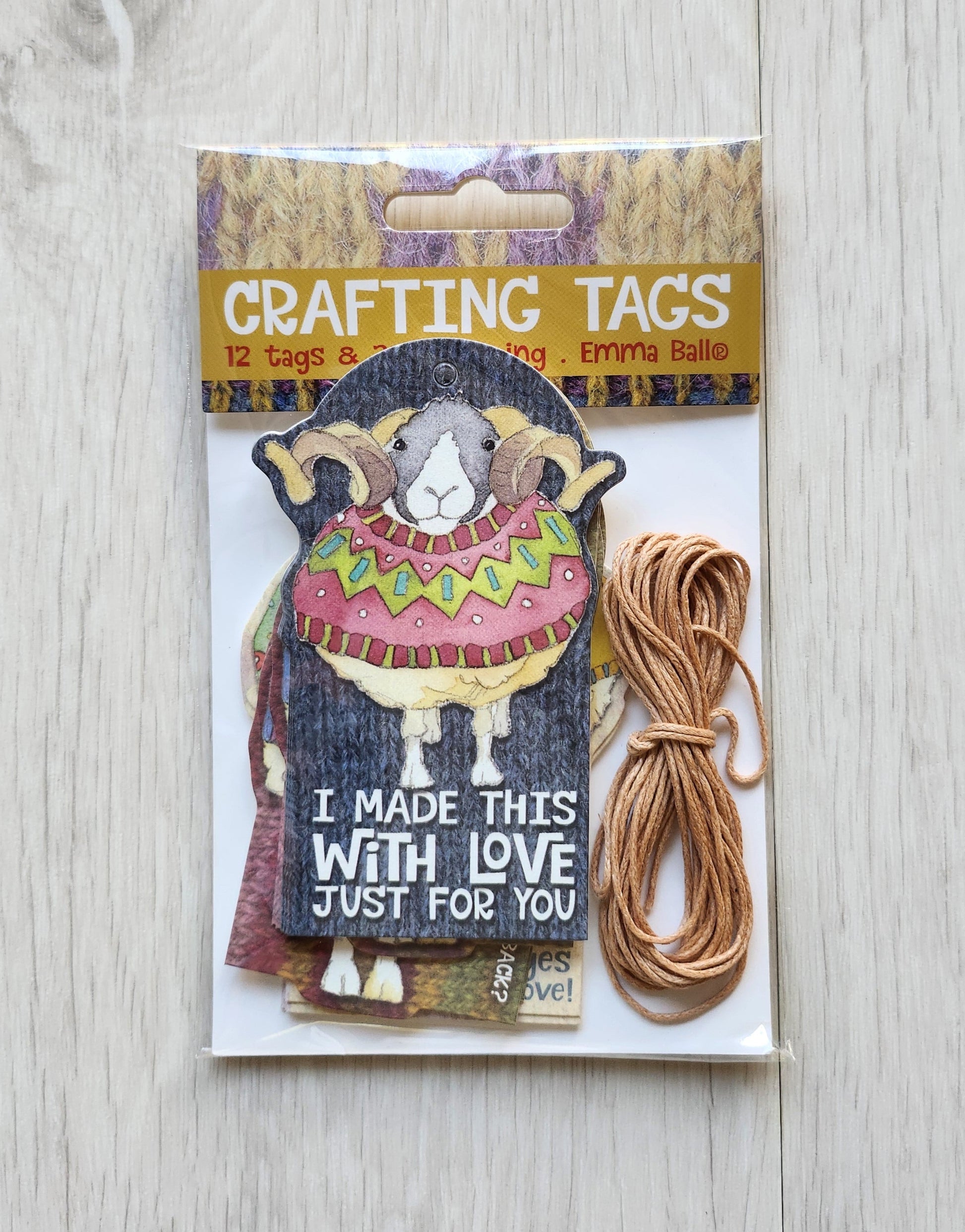 Packaging of 'Crafting Tags' with a decorative owl design on a light wooden surface.  Emma ball