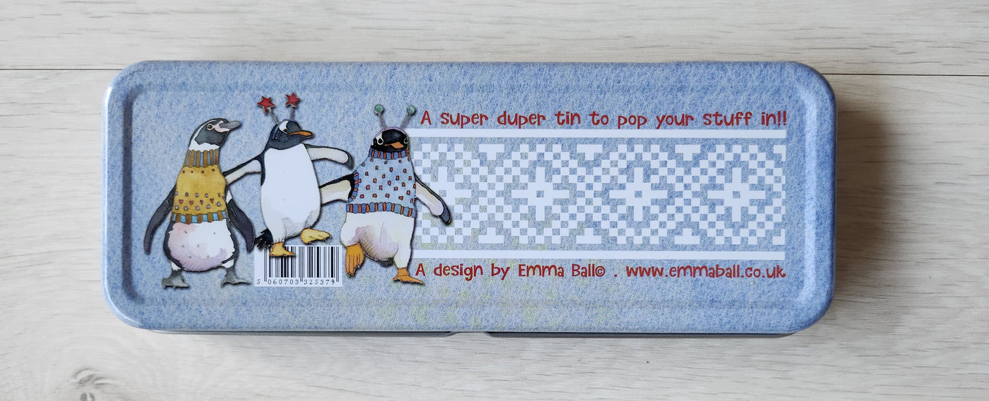 Pencil case with penguin design on a wooden surface