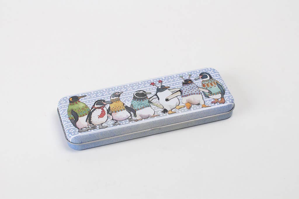 Metal pencil case with penguin design on a light gray background