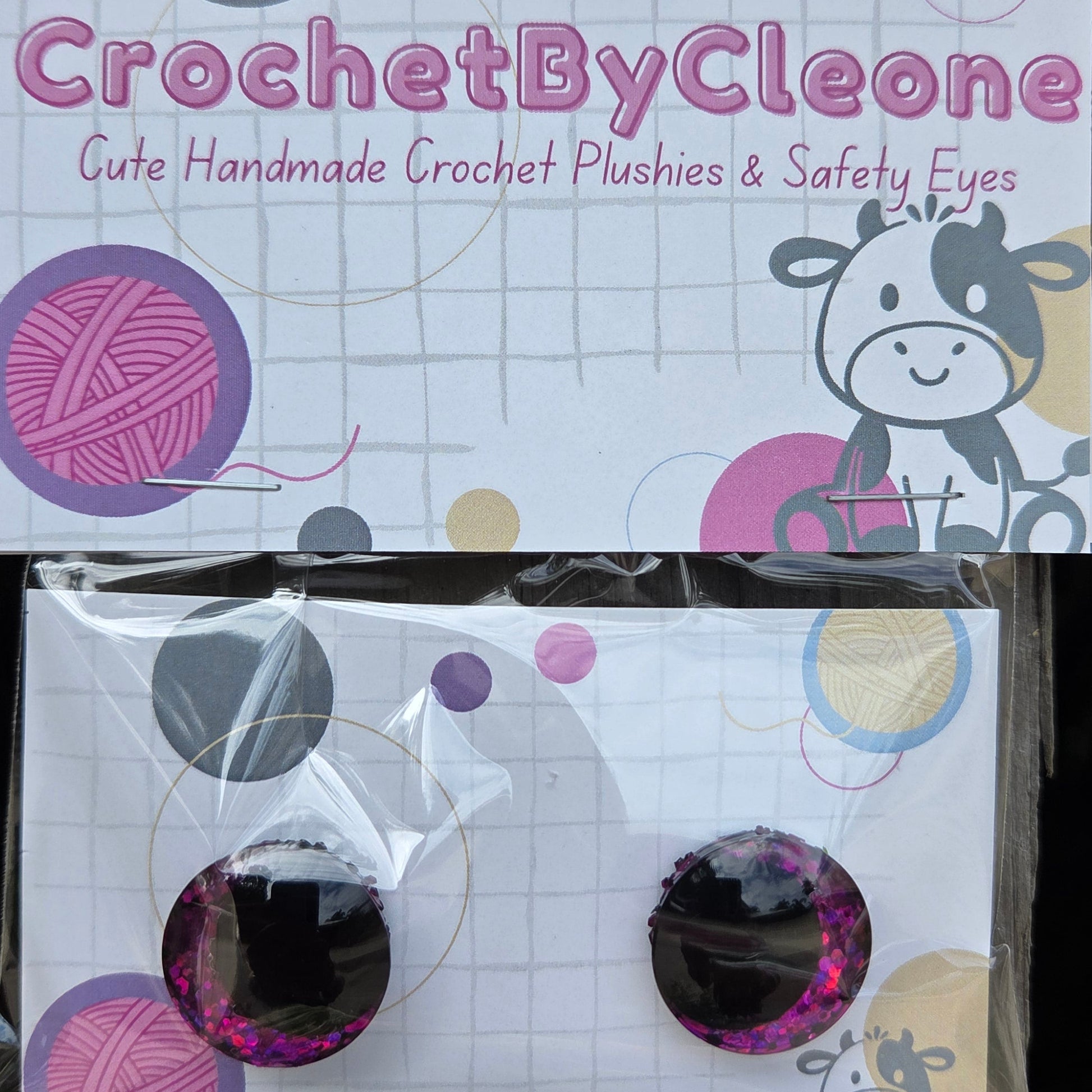 A pair of handmade crochet push-on eyes in a clear plastic bag, displayed next to its printed packaging card on a rustic wooden surface. The packaging features the brand name 'CrochetByCleone' in pink text alongside colorful yarn ball graphics.