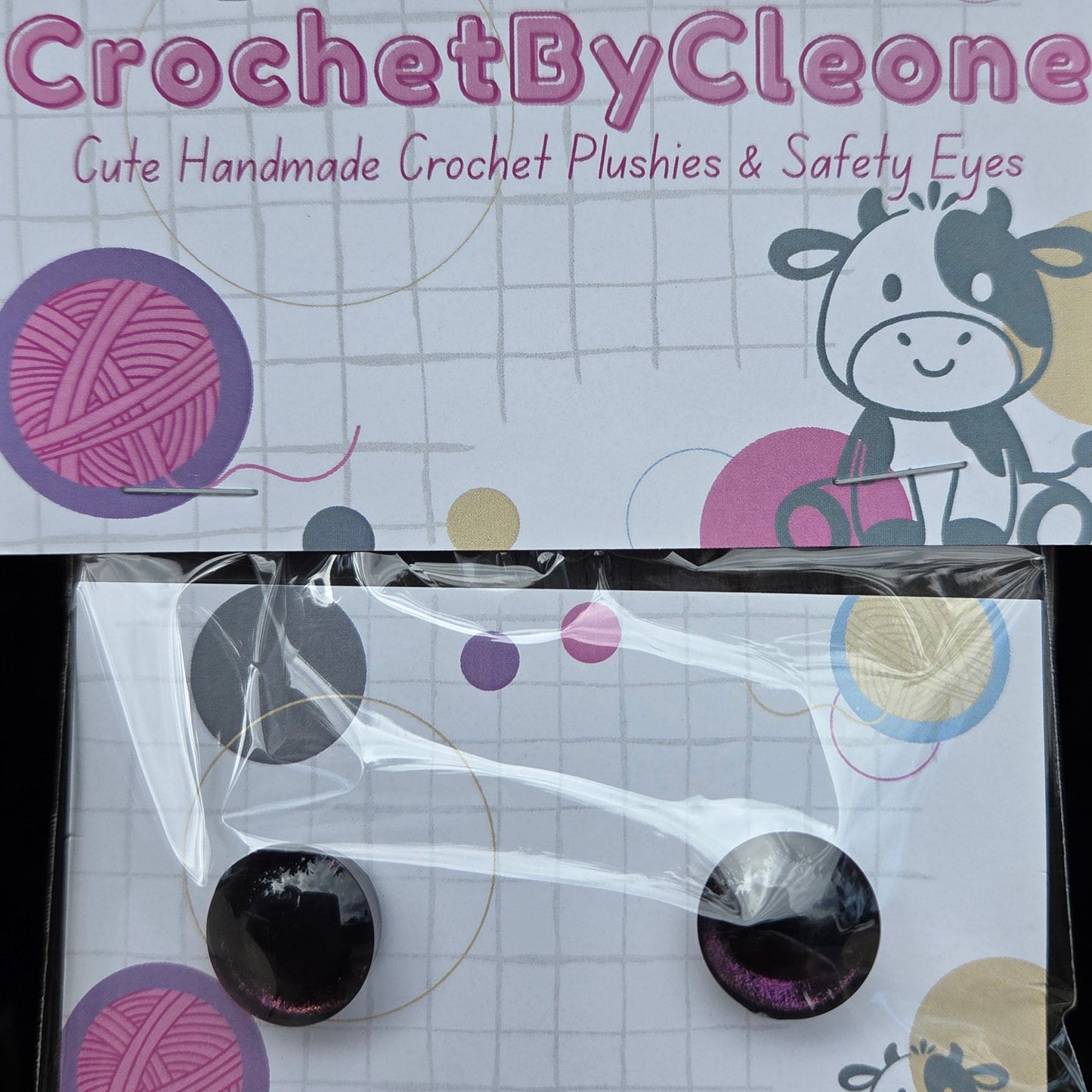 Two packaged crochet safety eyes displayed on branded cards. The left card shows the product packaging with the text 'CrochetByCleone' and 'Gute Handmade Crochet Plushies & Safety Eyes,' along with a cow illustration and yarn ball graphics.