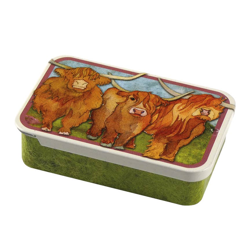 Rectangular tin box with highland cow design on a white background